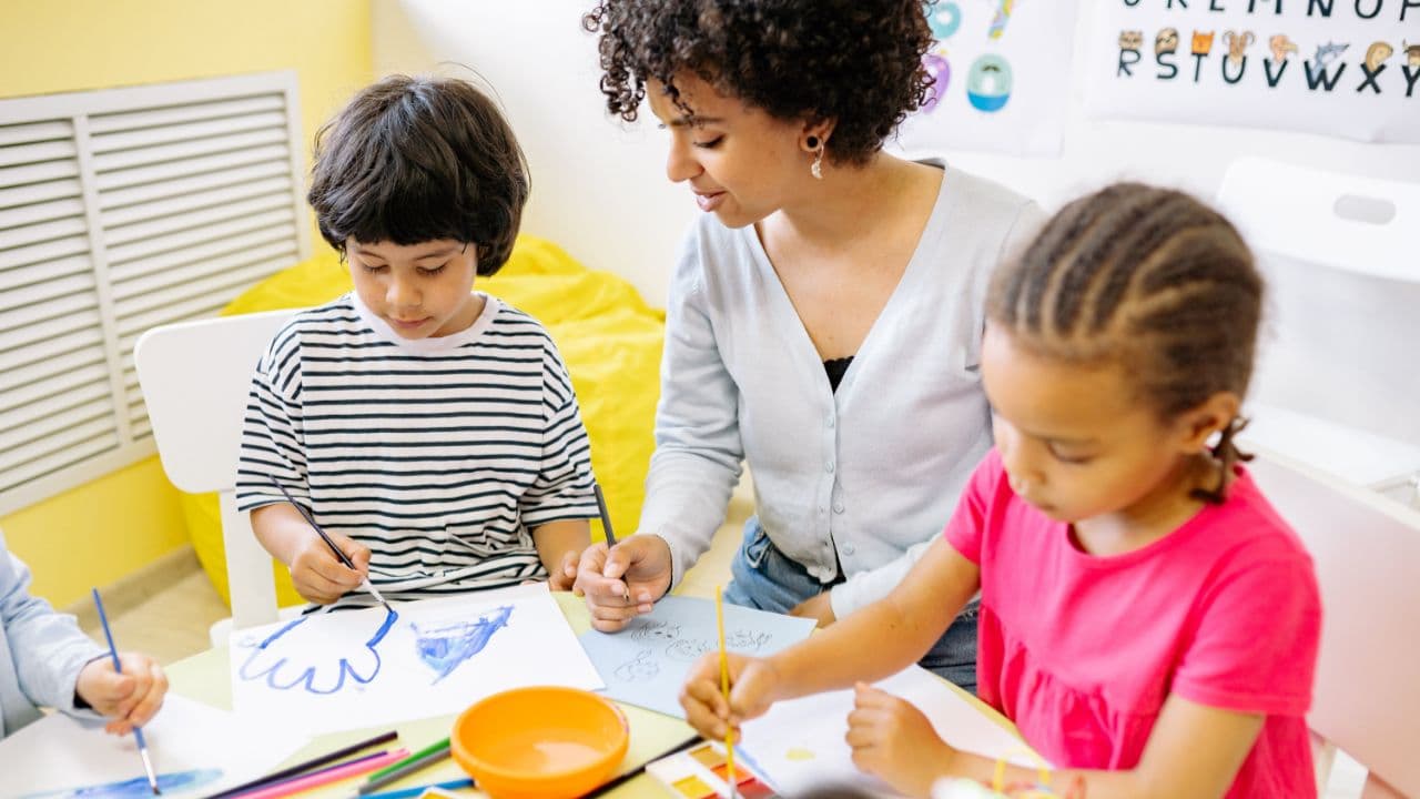 ABA Therapist working with kids at table